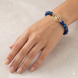 Designer Gold-Plated Trishul Rakhi with Dark Blue Stone Beads